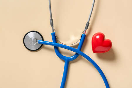 Modern stethoscope and heart on color backgroundの写真素材