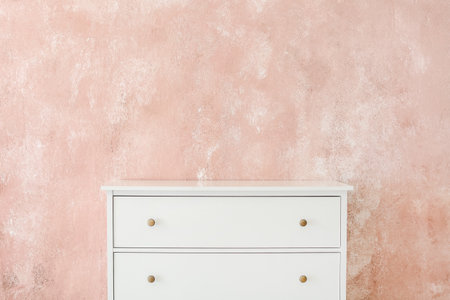 Stylish chest of drawers near color wallの写真素材