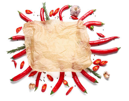 Frame made of baking parchment and chili peppers on white backgroundの写真素材