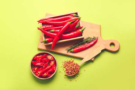 Composition with hot chili pepper on color background