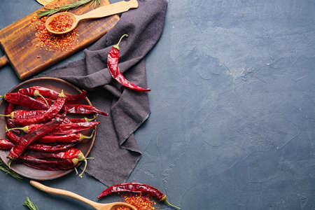 Composition with hot chili pepper on color backgroundの写真素材