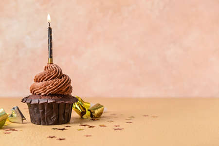 Tasty chocolate cupcake on color backgroundの写真素材