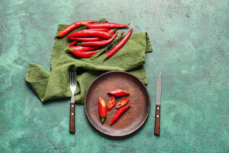 Composition with hot chili pepper on color backgroundの写真素材