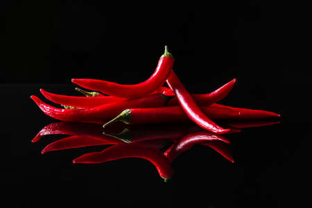 Hot chili peppers on dark backgroundの写真素材