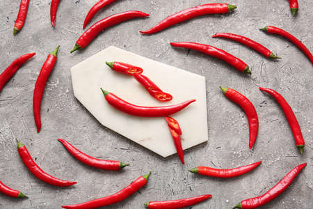 Composition with hot chili pepper on gray backgroundの写真素材
