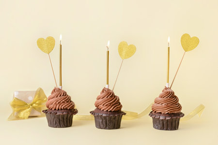 Tasty chocolate cupcakes on color backgroundの写真素材