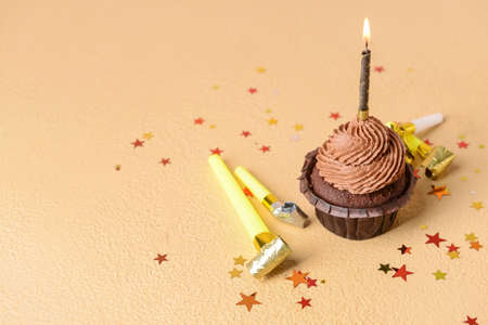 Tasty chocolate cupcake on color background