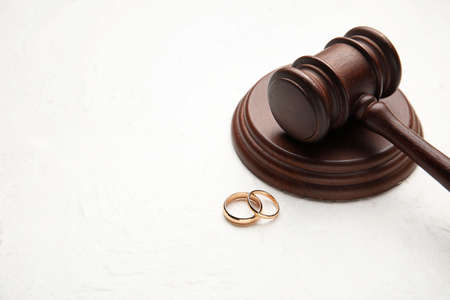 Judge's gavel with rings on light background