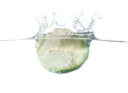 Falling of fresh cut cabbage into water against white backgroundの写真素材