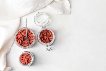 Jars with dried goji berries on light backgroundの写真素材