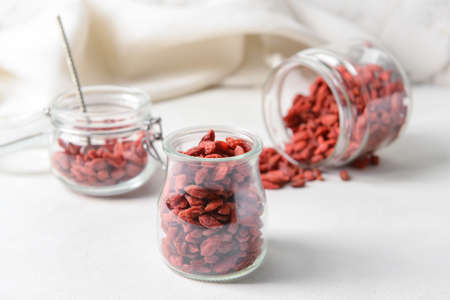 Jars with dried goji berries on light backgroundの写真素材