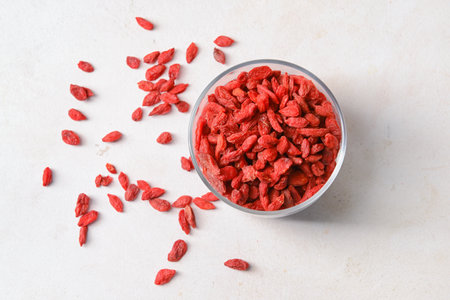 Bowl with dried goji berries on light backgroundの写真素材