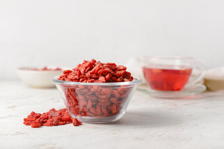 Bowl with dried goji berries on light backgroundの写真素材