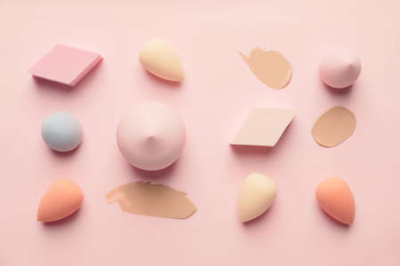 Makeup sponges with samples of tonal foundation on color backgroundの写真素材