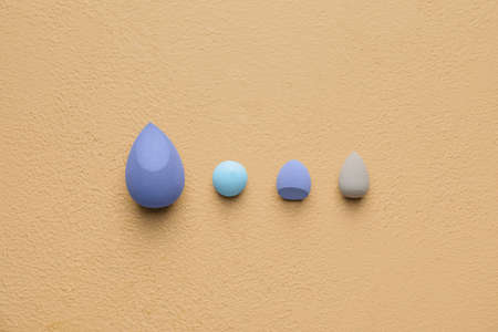 Makeup sponges on color background