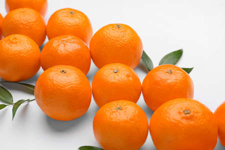 Composition with sweet tangerines and leaves on white background, closeupの写真素材