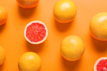 Ripe grapefruits on color backgroundの写真素材