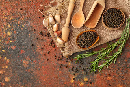 Bowls with peppercorns on grunge background