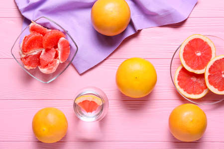Composition with ripe grapefruits on color wooden backgroundの写真素材