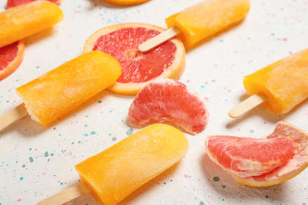 Tasty ice-cream and grapefruits on light backgroundの写真素材