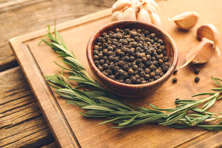 Bowl with peppercorns on wooden backgroundの写真素材