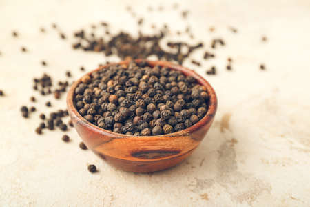 Bowl with peppercorns on light backgroundの写真素材