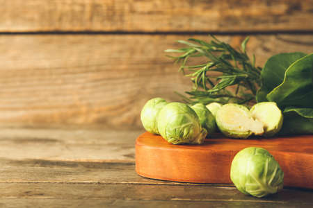 Board with green vegetables on wooden backgroundの写真素材