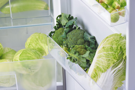 Fresh broccoli and cabbages in fridge, closeupの写真素材