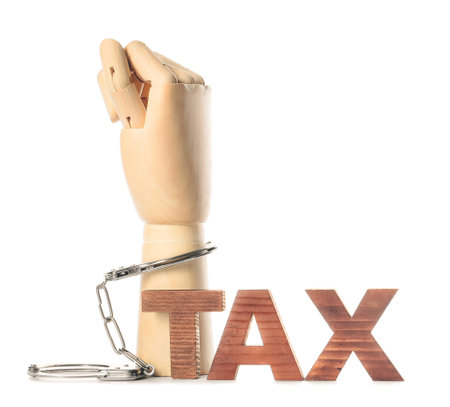 Word TAX and wooden hand with cuffs on white backgroundの写真素材