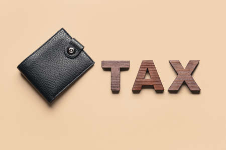 Wallet with word TAX on color backgroundの写真素材