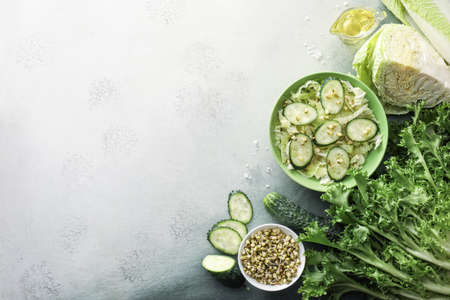 Bowl of tasty salad with fresh vegetables on light backgroundの写真素材