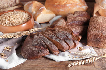 Fresh different bread on wooden background