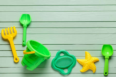 Set of beach toys for children on color wooden background