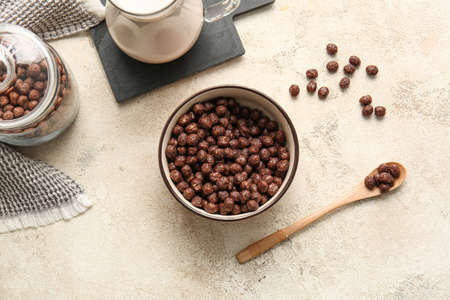 Bowl with chocolate corn balls on light backgroundの写真素材