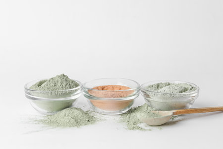 Bowls with different cosmetic clay on white backgroundの写真素材