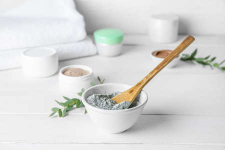 Bowl with cosmetic clay on light wooden backgroundの写真素材