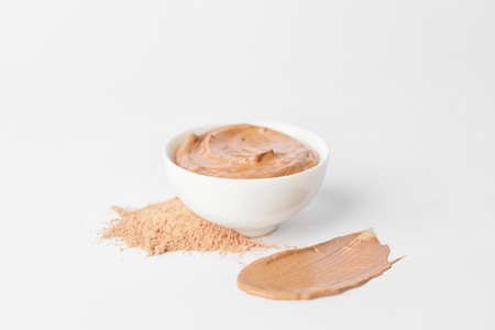 Bowl with cosmetic clay on white backgroundの写真素材