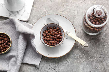 Bowl with chocolate corn balls on gray backgroundの写真素材