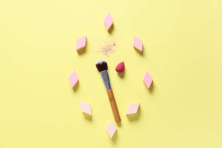 Makeup sponges and brush on color backgroundの写真素材