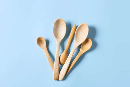 Different wooden spoons on color backgroundの写真素材