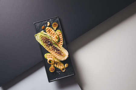 Board with tasty grilled vegetables on dark backgroundの写真素材
