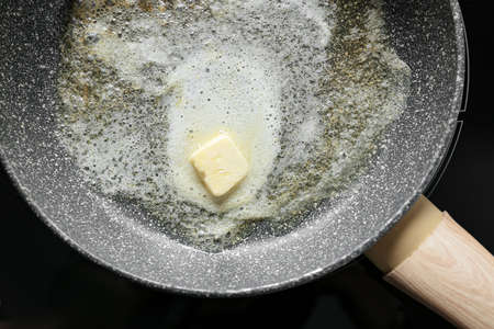 Melted butter in frying pan, closeup
