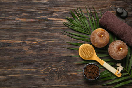 Beautiful spa composition with burning candles and palm leaf on wooden backgroundの写真素材