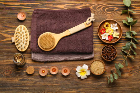 Beautiful spa composition with burning candles and flowers on wooden backgroundの写真素材