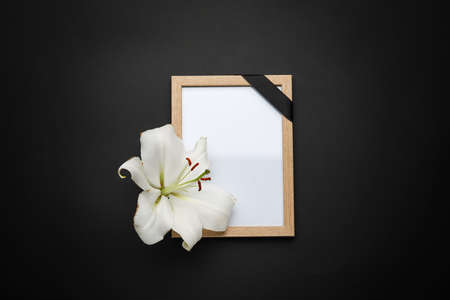 Photo frame with lily flower on dark backgroundの写真素材