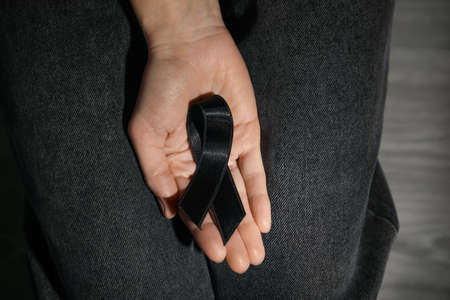 Woman with black funeral ribbon, closeupの写真素材