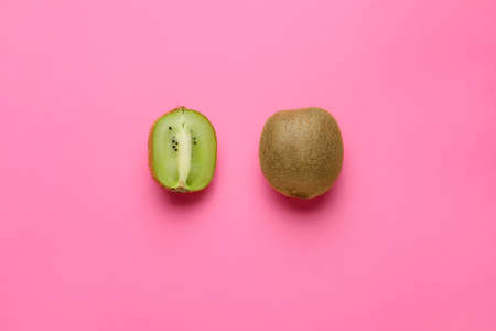 Many tasty kiwi on color background