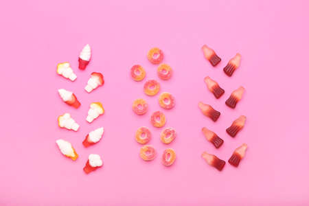 Different jelly candies on color backgroundの写真素材