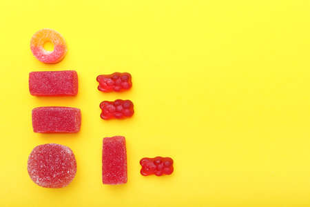 Different jelly candies on color backgroundの写真素材