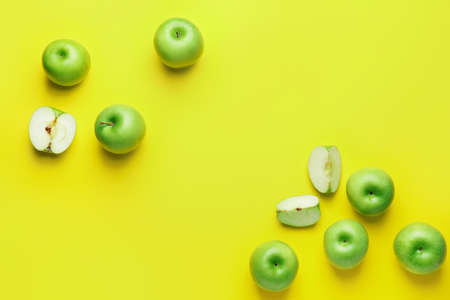 Fresh green apples with pieces on color backgroundの写真素材
